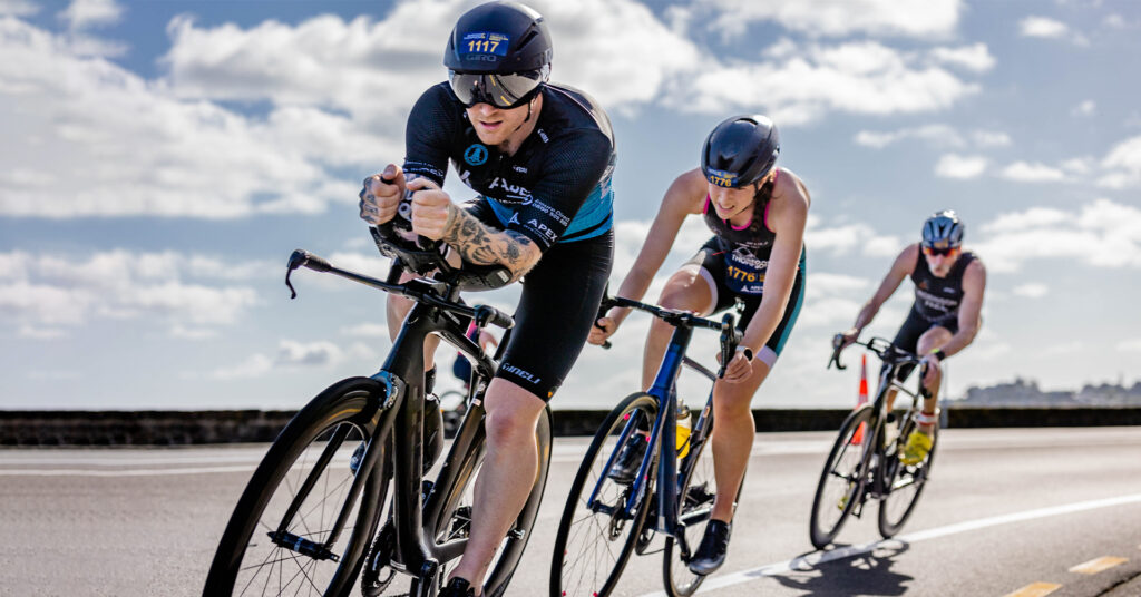 Athletes racing along the waterfront at People’s Triathlon.